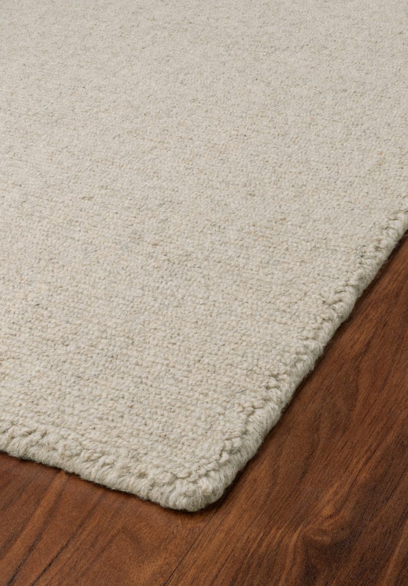 Angled floor view of Solid Barley Natural Wool Loom-Hooked Rug